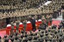 North Korean leader Kim Jong Un waves during a performance by the State Merited Chorus