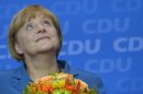 German Chancellor Angela Merkel smiles as she celebrates in Berlin on September 22, 2013