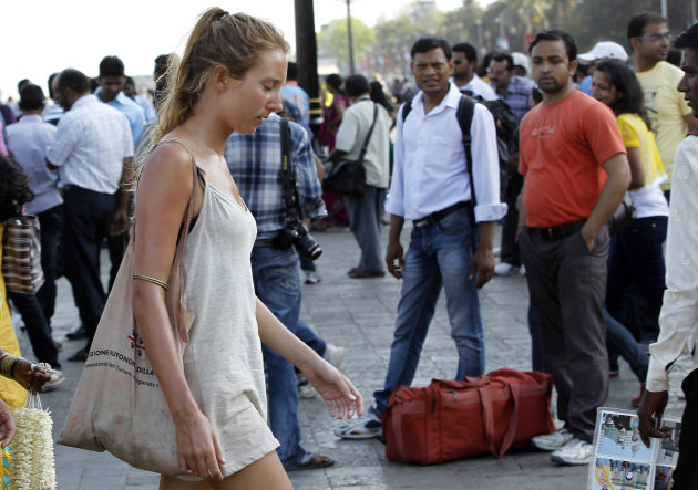 In this Tuesday, April 2, 2013 photo, German tourist Carolina De Paola, 22, walks near the landmark Gateway of India in Mumbai, India. A fatal gang rape in New Delhi didn't deter Germans De Paolo and Canan Wahner from traveling to India for a six-week tour. On a train, a man grabbed De Paolo's breasts from behind but she never reported the crime, deciding there would be no point. Violence against women, and the huge publicity generated by recent attacks here, is threatening India's $17.7 billion tourism industry with a new study showing tourism has plunged. (AP Photo/Rajanish Kakade)