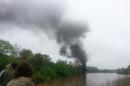 In this mobile phone photo provided Allison Hallock, people watch smoke rise from a bridge over the James river after several CSX tanker cars carrying crude oil derailed, Wednesday, April 30, 2014, in Lynchburg, Va. Authorities evacuated numerous buildings Wednesday after the derailment. (AP Photo/Ali Hallock) MANDATORY CREDIT