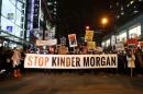 Protesters walk down Robson Street in opposition to Canada's decision to approve Kinder Morgan Inc's pipeline from the Alberta oil sands to the Pacific coast in Vancouver