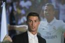Real Madrid's Cristiano Ronaldo leaves a press conference after signing a new contract at the Santiago Bernabeu stadium in Madrid, Spain, Monday, Nov. 7, 2016. Real Madrid have extended Ronaldo's contract until June 2021, when the three-time world player of the year will be 36. Financial details were not released, although the star forward is expected to remain the team's top-paid player. (AP Photo/Paul White)