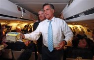 U.S. Republican presidential nominee and former Massachusetts Governor Mitt Romney (R) is joined by Sen. Rob Portman (R-OH) hands out birthday cake on his campaign plane on their way to Bedford, Massachusetts, September 14, 2012. REUTERS/Jim Young