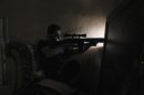 A Free Syrian Army sniper takes a shooting position in Aleppo's Bustan al-Qasr