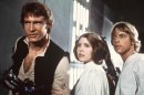 This publicity film image provided by 20th Century-Fox Film Corporation shows, from left, Harrison Ford as Han Solo, Carrie Fisher as Princess Leia Organa and Mark Hamill as Luke Skywalker in a scene from the "Star Wars" movie released by 20th Century-Fox in 1977. The classic Star Wars film that launched a science fiction empire is being dubbed in the Navajo language, with casting calls scheduled Monday, April 29, 2013, in Burbank, Calif., and on May 3 and 4 at the Navajo Nation Museum in Window Rock. Potential actors don't have to sound exactly like Princess Leia, Luke Skywalker or Han Solo, but should be able to deliver the lines with character. (AP Photo/20th Century-Fox Film Corporation)