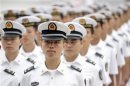 PLA navy sailors stand in a line and wait to attend a ceremony at the Great Hall of the People in Beijing