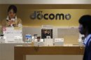 The logo of Japan's biggest mobile phone operator NTT Docomo is seen at its shop in Tokyo