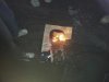 Demonstrators burn a photograph of Syria's President Bashar al-Assad during a protest at Yabroud