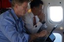 Republican presidential nominee Mitt Romney sits with senior advisor Stuart Stevens on his campaign plane enroute to Des Moines