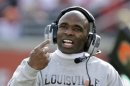 Louisville coach Charlie Strong directs his team against Connecticut during an NCAA college football game in Louisville, Ky., Saturday, Nov. 24, 2012. UConn 23-20 in triple overtime. (AP Photo/Garry Jones)
