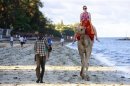 A tourist rides on a camel's back at the Jomo Kenyatta public beach in Mombasa