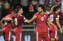 Qatar players celebrate scoring a goal during the 2018 World Cup qualifying match against Hong Kong in Doha