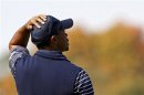 U.S. golfer Woods reacts after missing a birdie putt to lose the second hole during the afternoon four-ball round at the 39th Ryder Cup golf matches at the Medinah Country Club
