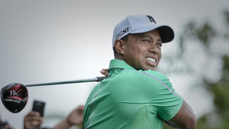 Tiger Woods tees off during his one-on-one golf matchup against Rory McIlroy at Mission Hills in Haikou on October 28, 2013