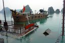 FILE - In this Feb. 18, 2011 file photo, a tour boat, submerged in the water, is pulled up in the Halong Bay in northern Quang Ninh province, Vietnam, a day after 12 people from nine nations died when their boat sank early in the morning. Each day, up to 10,000 tourists from around the world sail around the bay, a UNESCO-heritage site and one of the country's most visited tourist attractions, and gaze at its stunning limestone pillars and caves. But at least four deadly accidents over the last 10 years and many more alarming safety incidents recounted on traveler's blogs have led to allegations that the ships are cutting corners. (AP Photo/Dinh Tran Trung Hau, File)