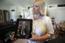 FILE - In this July 13, 2016 file photo, Laurie Holt holds a photograph of her son Joshua Holt at her home, in Riverton, Utah. At a press conference Tuesday, Oct. 11, 2016, attorney Jeanette Prieto said Holt was stripped naked and made to perform exercises in a hallway. She said the mistreatment violated international treaties. (AP Photo/Rick Bowmer, File)
