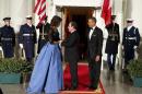 First lady Michelle Obama, left, and President Barack Obama welcome French President François Hollande for a State Dinner at the North Portico of the White House on Tuesday, Feb. 11, 2014, in Washington. (AP Photo/ Evan Vucci)