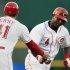 Cincinnati Reds' Brandon Phillips (4) is congratulated by third base coach Mark Berry (41) after Phillips hit a solo home run in the first inning of a baseball game against the Pittsburgh Pirates, Tuesday, Sept. 11, 2012, in Cincinnati. (AP Photo/Al Behrman)