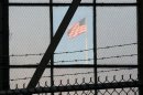 In this photo reviewed by the U.S. Department of Defense, a U.S. flag waves above the the Camp Justice compound, during day three of pre-trial hearings for the five Guantanamo prisoners accused of orchestrating the Sept. 11, 2001 attack, at Guantanamo Bay U.S. Naval Base, Cuba, Wednesday, Oct. 17, 2012. The the five Guantanamo prisoners face charges that include terrorism, conspiracy and 2,976 counts of murder, one count for each known victim of the attacks at the time the charges were filed. They could get the death penalty if convicted. (AP Photo/Toronto Star, Michelle Shephard, Pool)