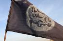 A Boko Haram flag flutters from an abandoned command post in Gamboru, February 4, 2015