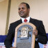 FILE - In this July 22, 2012, file photo, former Cincinnati Reds star Barry Larkin holds his plaque after his induction into the National Baseball Hall of Fame and Museum during a ceremony in Cooperstown, N.Y. Larkin wants to keep baseball's most exclusive club clean.  Inducted into the Hall of Fame last summer, he told The Associated Press in a phone interview Wednesday, Dec. 5, 2012, that players who cheat shouldn't receive baseball's highest individual honor. (AP Photo/Tim Roske, FIle)