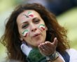 Italian fan with her face painted blows a kiss as she waits for the start of the Group C Euro 2012 soccer match against Spain in PGE Arena in Gdansk