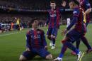Barcelona's Luis Suarez, left, celebrates with team mates after scoring his team's second goal during a Spanish La Liga soccer match between FC Barcelona and Real Madrid at Camp Nou stadium, in Barcelona, Spain, Sunday, March 22, 2015. (AP Photo/Manu Fernandez)