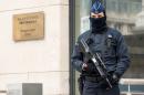 A Policeman guards the Belgian Federal Prosecutor's office in Brussels, Friday, Jan. 16, 2015. Thirteen people were detained in Belgium and two arrested in France in an anti-terror sweep following a firefight in which two suspected terrorists were killed in the eastern city of Verviers on Thursday. (AP Photo/Geert Vanden Wijngaert)
