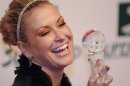 U.S. singer Anastacia holds the Women's Artist Award during the Women's World Awards gala in Vienna