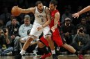Brooklyn Nets point guard Deron Williams is defended by Toronto Raptors point guard Jose Calderon in the first quarter of their NBA basketball game in New York