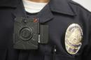 This Jan. 15, 2014 file photo shows a Los Angeles Police officer wearing an on-body cameras during a demonstration for media in Los Angeles. Thousands of police agencies have equipped officers with cameras to wear with their uniforms, but they've frequently lagged in setting policies on how they're used, potentially putting privacy at risk and increasing their liability. As officers in one of every six departments across the nation now patrols with tiny lenses on their chests, lapels or sunglasses, administrators and civil liberties experts are trying to envision and address troublesome scenarios that could unfold in front of a live camera. (AP Photo/Damian Dovarganes)