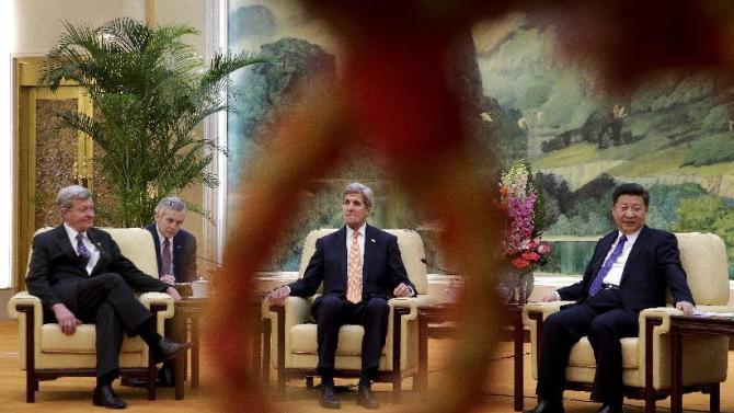 U.S. Secretary of State John Kerry, center, is seen through a loop of a rope used as a security line for the media as he and U.S. Ambassador to China Max Baucus, left, meet with Chinese President Xi Jinping at the Great Hall of the People in Beijing, Wednesday, Jan. 27, 2016. (AP Photo/Andy Wong, Pool)