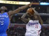 Los Angeles Clippers guard Jamal Crawford, right, puts up a shot as Oklahoma City Thunder guard Reggie Jackson defends during the first half of their NBA basketball game, Tuesday, Jan. 22, 2013, in Los Angeles.  (AP Photo/Mark J. Terrill)