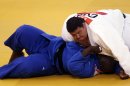 Guam's Ricardo Blas Jr. and Guinea's Facinet Keita compete during the men's 100-kg judo competition at the 2012 Summer Olympics, Friday, Aug. 3, 2012, in London. (AP Photo/Mike Groll)