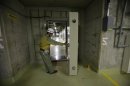 File photo shows an employee opening the watertight door of an emergency electric panel room in the No.4 reactor building at Chubu Electric Power Co.'s Hamaoka Nuclear Power Station in Omaezaki