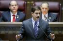 Arizona Republican Gov. Doug Ducey, front, gives his state-of-the-state address as Arizona House speaker David Gowan, left, R-Sierra Vista, and Arizona Senate President Andy Biggs, right, R-Gilbert, listen at the Arizona Capitol Monday, Jan. 12, 2015, in Phoenix. (AP Photo/Ross D. Franklin)