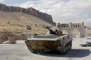 A Russian made Syrian armoured personnel carrier roles along a street leading into Maalula on September 18, 2013