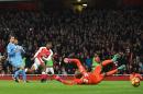 Arsenal's Alex Iwobi (3L) shoots and scores past Stoke City's goalkeeper Lee Grant at the Emirates Stadium in London