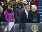 First lady Michelle Obama and daughter Malia watch as U.S. President Barack Obama is greeted by Vice President Biden as he arrives for his swearing-in ceremonies on the West Front of the U.S. Capitol in Washington