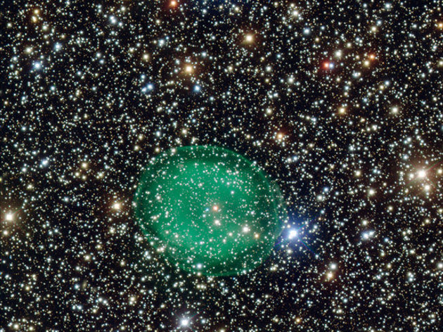 this photo shows the glowing green planetary nebula IC 1295 surrounding a dim and dying star. It is located about 3300 light-years away from Earth.