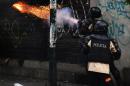 Riot policemen shoot tear gas during a protest against Venezuelan President Nicolas Maduro in Caracas, on March 22, 2014
