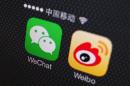 A picture illustration shows icons of WeChat and Weibo app in Beijing
