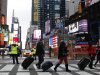 People pull their luggage at Times Square as Hurricane Sandy approaches New York