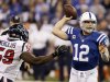 Indianapolis Colts' Andrew Luck (12) throws while pressured by Houston Texans' Whitney Mercilus (59) during the first half of an NFL football game on Sunday, Dec. 30, 2012, in Indianapolis. (AP Photo/Darron Cummings)