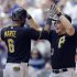 Pittsburgh Pirates' Starling Marte, left, and Travis Snider high-five after Marte's two-run home run against the Milwaukee Brewers in the eighth inning of a baseball game Wednesday, May 1, 2013, in Milwaukee. (AP Photo/Jeffrey Phelps)