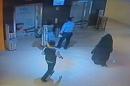 A fully veiled woman (R), the suspect in the killing of an American teacher in a shopping mall toilet, is shown walking through the mall in the Emirati capital in this CCTV image released by Abu Dhabi police on December 3, 2014