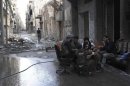 Free Syrian Army members eat a meal together in one of the streets of Deir el-Zor