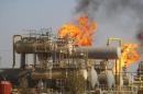 Oil down as Iraq says no cuts; Wall Street, Cushing draw limit loss