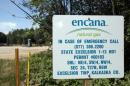 An Encana natural gas sign is seen near a production well for natural gas and oil in a state forest park in Kalkaska