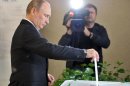Vladimir Putin votes at a polling station during a mayoral election in Moscow, on September 8, 2013